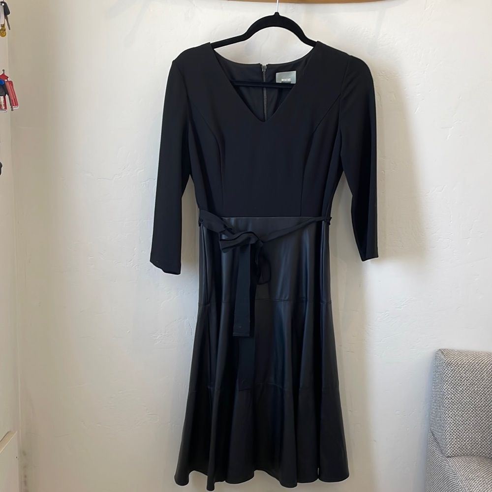 Black 3/4 sleeve cocktail dress. Jersey fabric on top . Faux leather shirt .